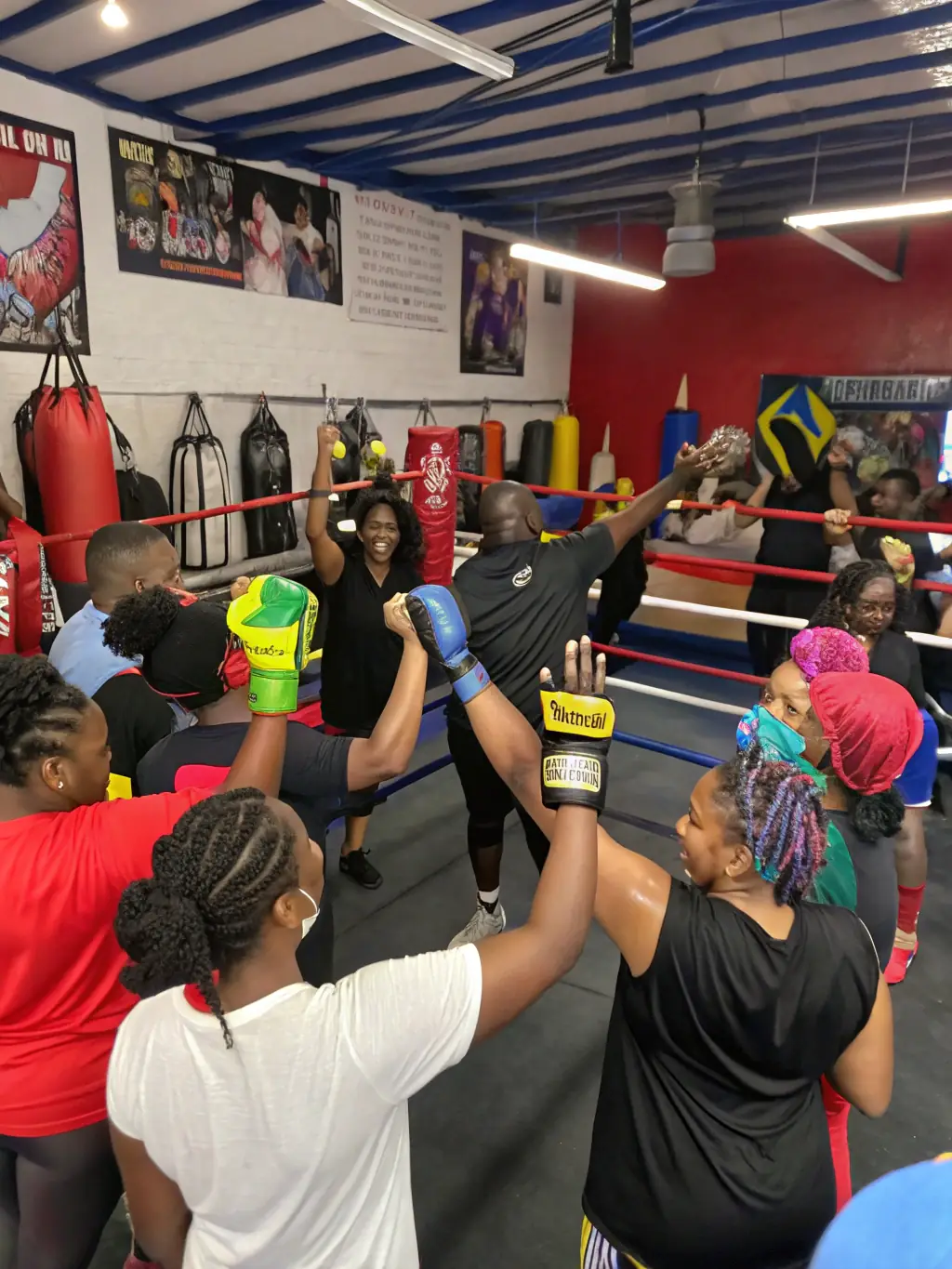 A diverse group of savate boxers training together in a well-equipped gym, showcasing the camaraderie and inclusive environment of the club.